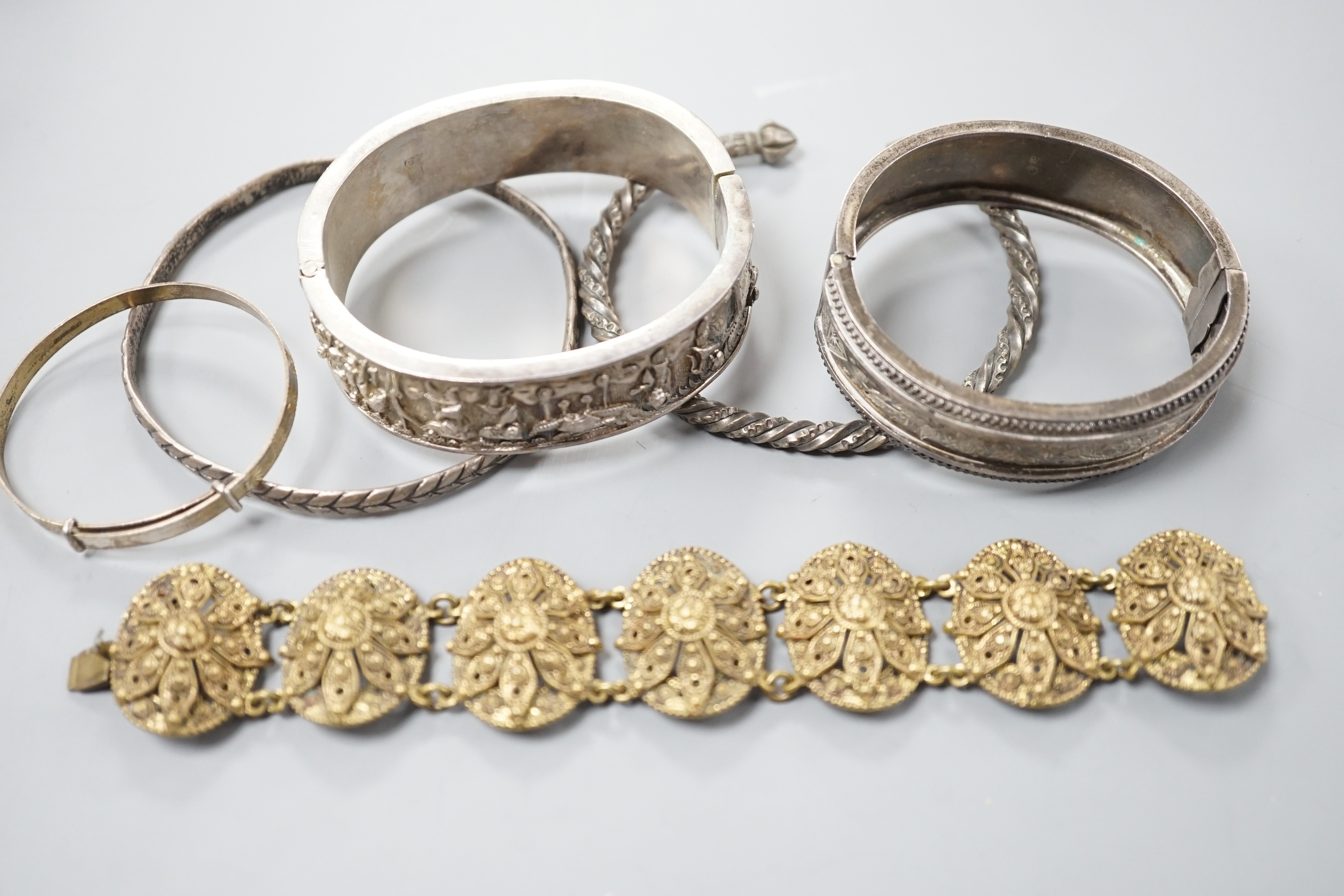 A Chinese white metal hinged bangle and five other items, including an engraved silver hinged bangle.